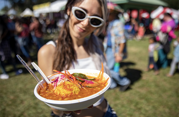 person holding Cajun seafood dish