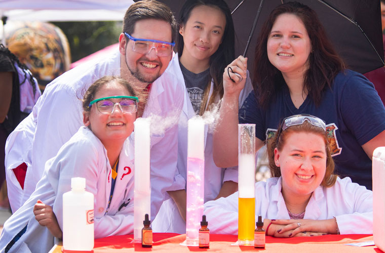 Students from the American Chemistry Society student organization showing off their booth on the University of Louisiana at Lafayette campus 
