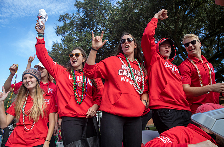 waterski team throwing beads at parade
