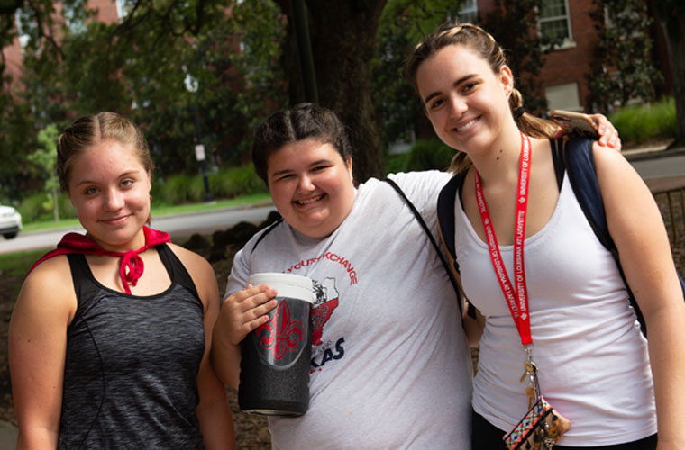 Three University of Louisiana at Lafayette students walking on campus from the dorms to the Student Union