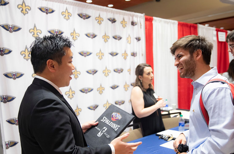 A University of Louisiana at Lafayette students talks to a career recruiter from the professional sports teams New Orleans Saints and Pelicans