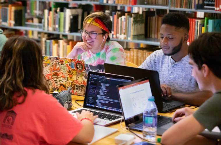 A group of UL Lafayette students studying together on their laptops