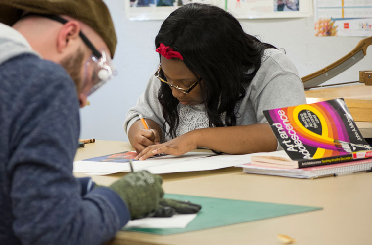 A student majoring in art education at UL Lafayette works on a painting project
