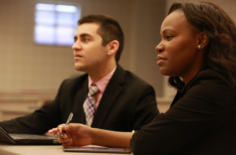 Two University of Louisiana at Lafayette business professionals sitting together.