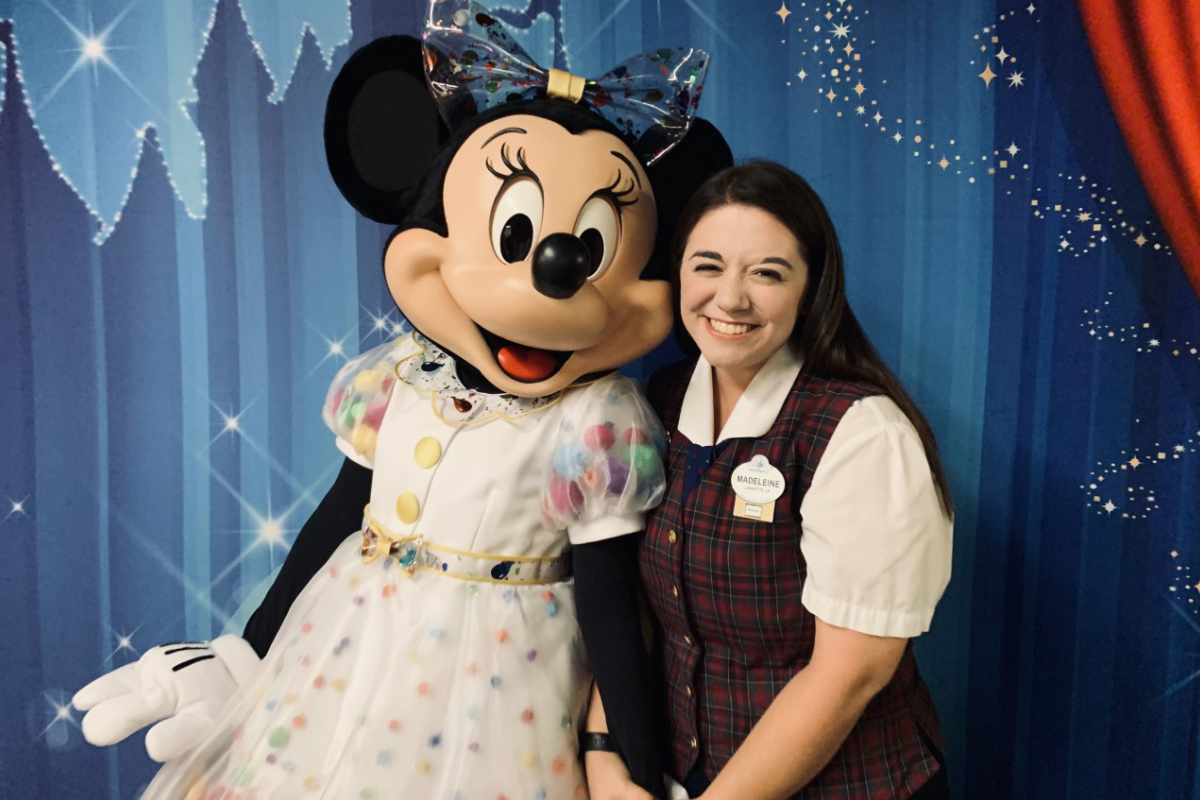 University of Louisiana at Lafayette alum Madeleine Comeaux stands with Disney's Minnie Mouse.