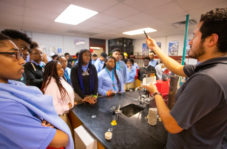 Engineering students observing presentation on oil.