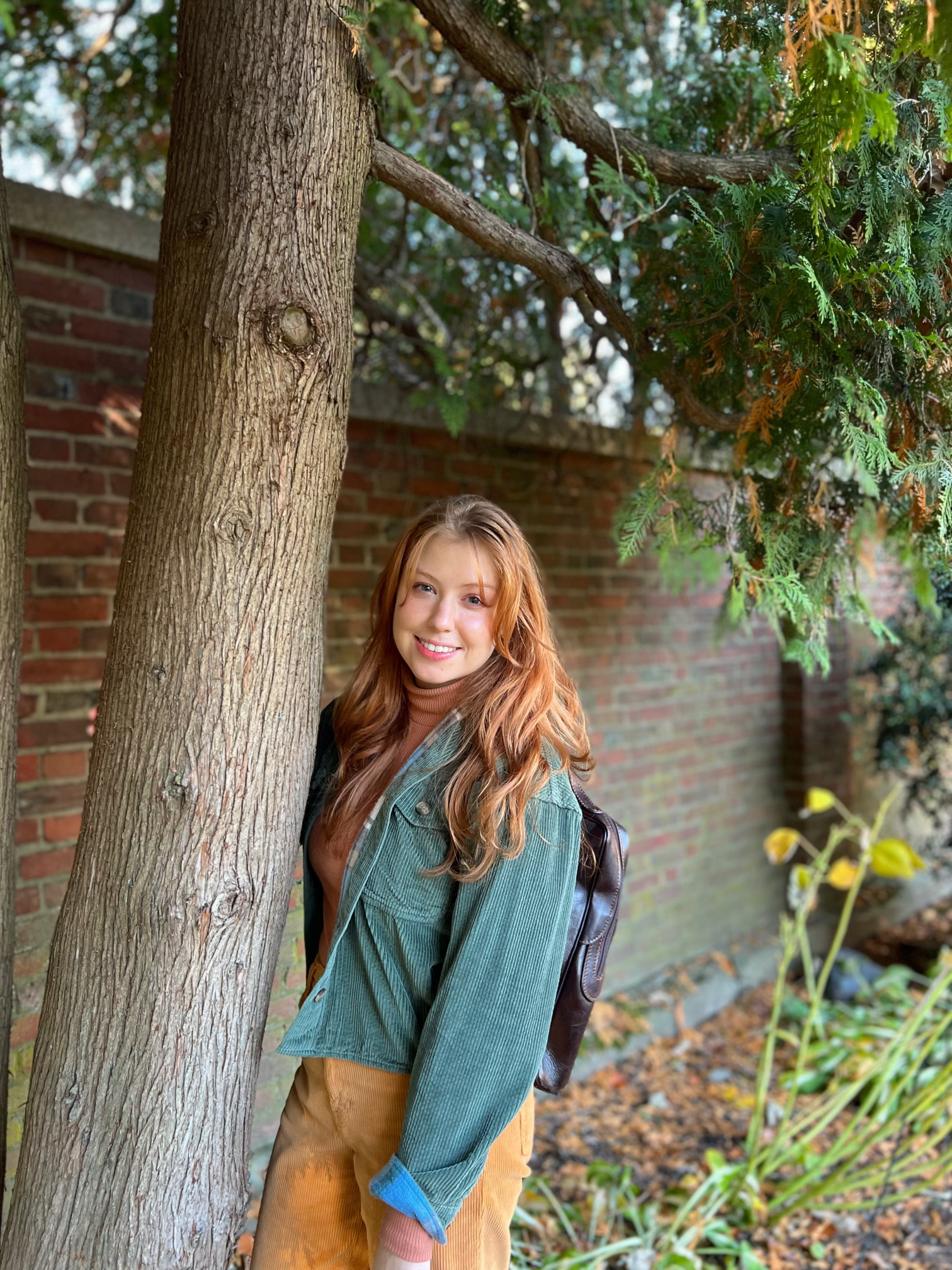 Sydney Doyle standing beside a tree