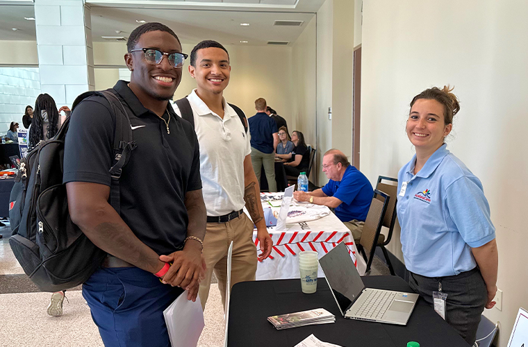 Students interacting with an employer at a Career Fair