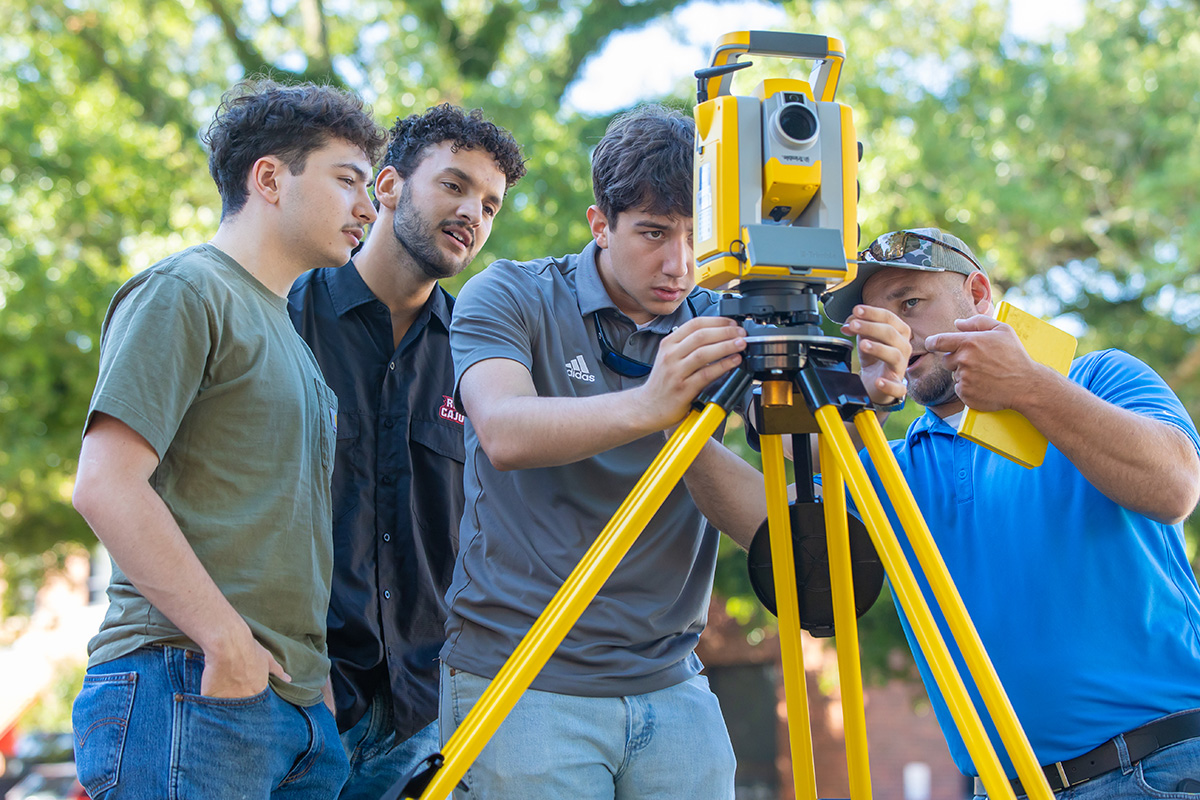 Student engineers work with equipment 