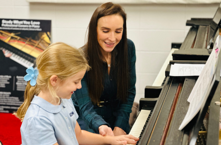 Teacher teaching student piano