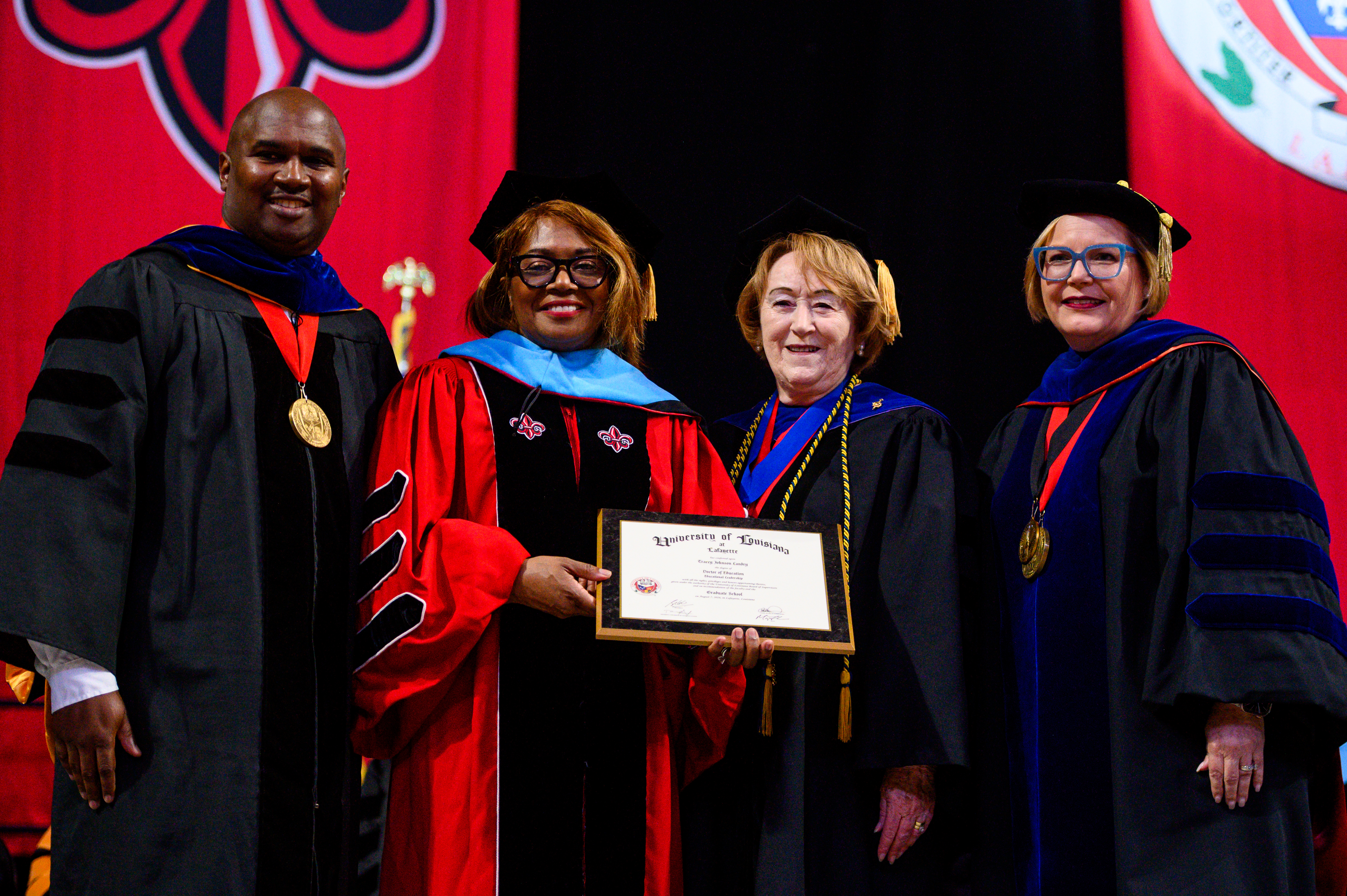 An Ed.D. grad with her chair, department head, and Dean Mary Farmer-Kaiser