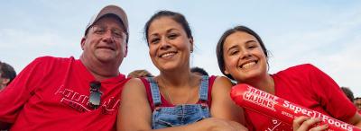 A UL Lafayette student with her parents in the stands at a Louisiana Ragin' Cajuns football game