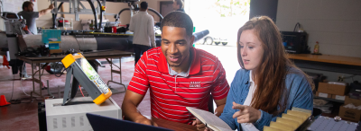 Two University of Louisiana at Lafayette students work on research under expert faculty in a lab