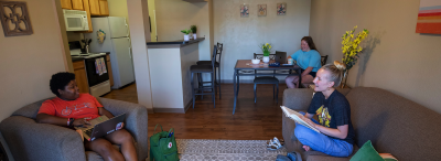 Students sit in a Legacy Park apartment living room