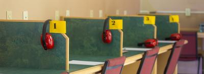 A row of testing stations with noise cancelling headphones in UL Lafayette's testing center
