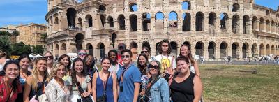 A group of UL Lafayette students standing in front of the colosseum on a study abroad trip
