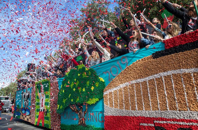 Red and white confetti around a float on St. Mary Boulevard for UL Lafayette Homecoming